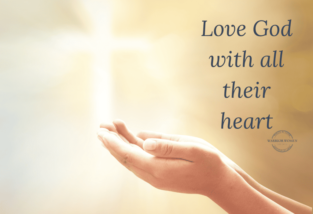 woman's hands cupped and lifted toward sky with faint glowing cross above them prayer to love God with all their heart