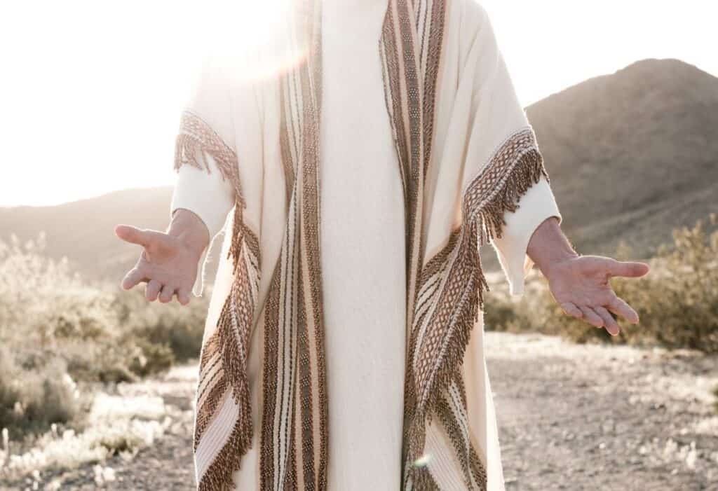 man representing Jesus with arms outstretched