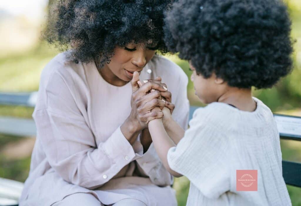 mother praying with her daughter