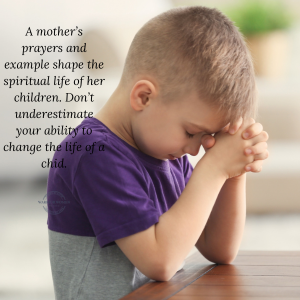 little boy with elbows on table praying
