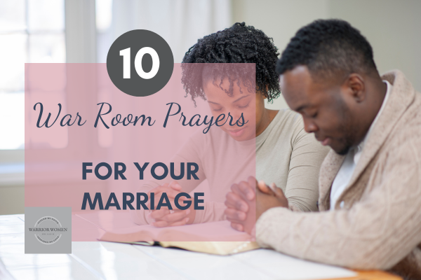 Man and woman praying together over an open Bible