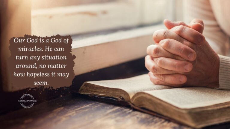 praying for prodigals: woman's hands clasped in prayer over an open Bible by a window