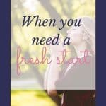 woman with praying hands in front of a tree